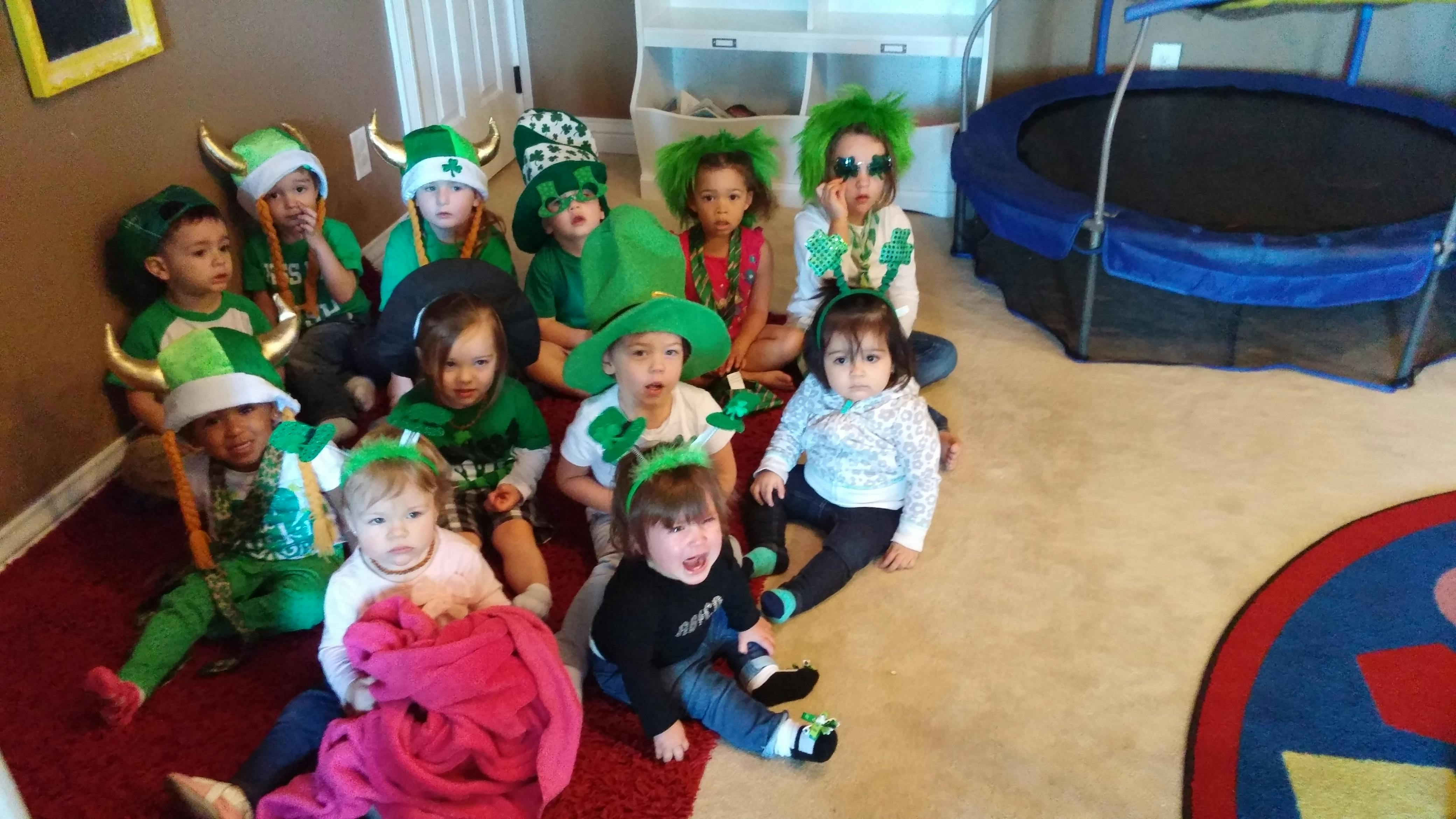 Group of children wearing green St Patrick's Day themed costumes