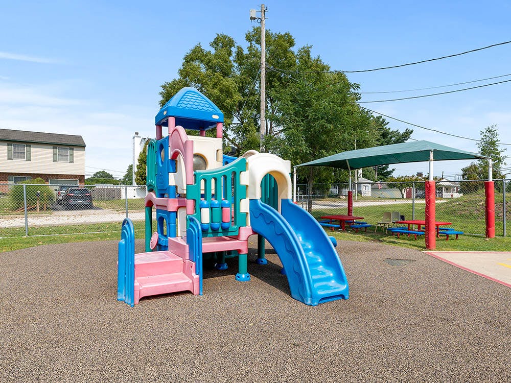 Colorful playground structure with slides and stairs