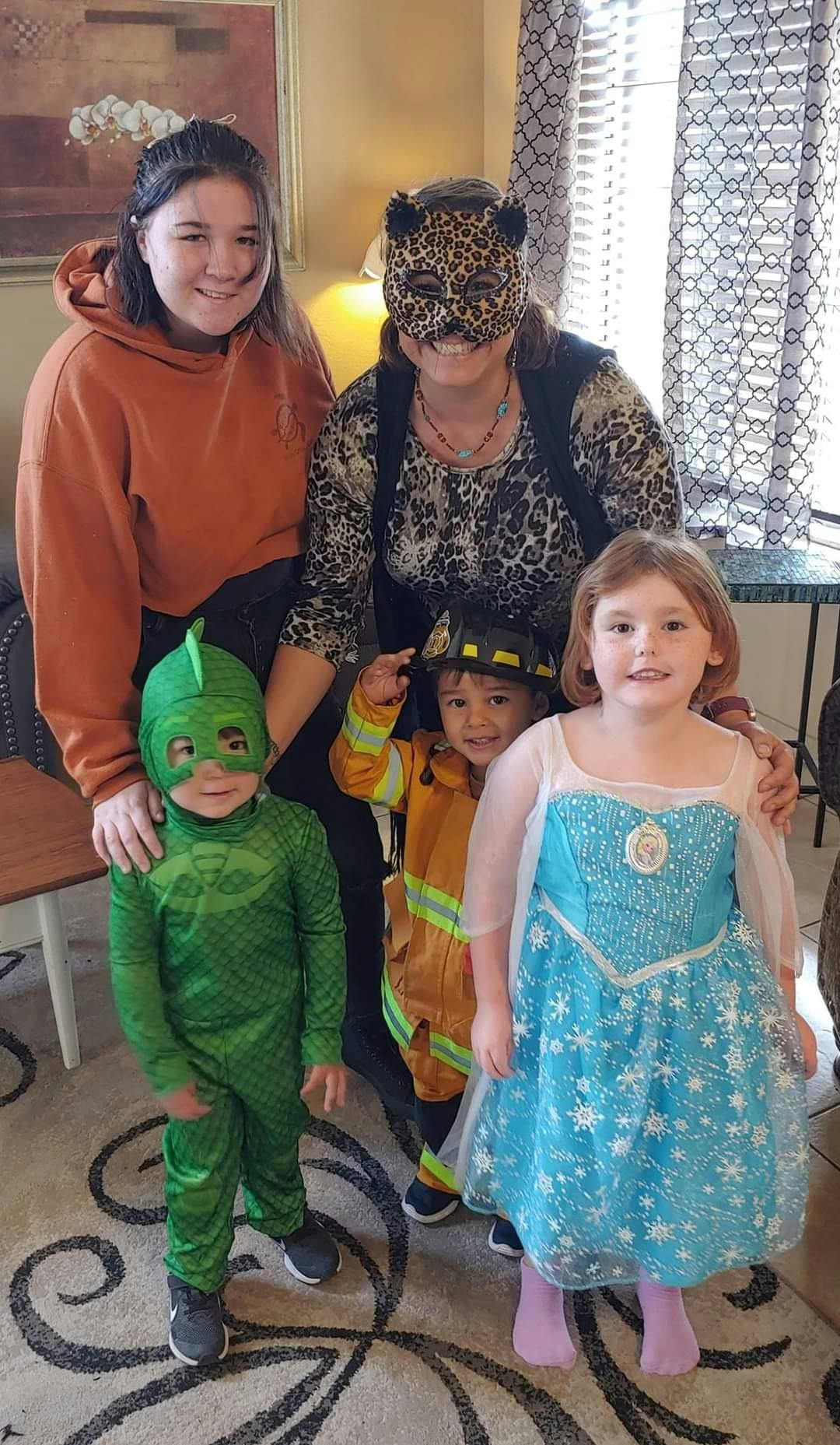 Two adults and three children in costumes