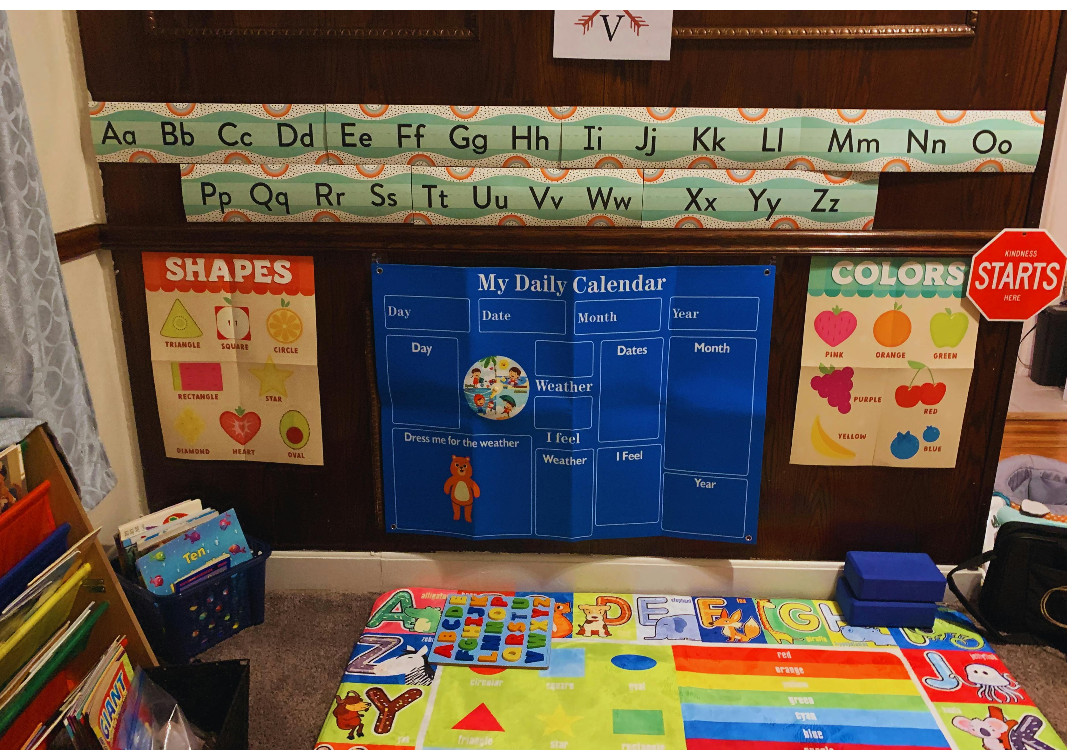 Educational wall charts for children featuring letters, shapes, and a calendar