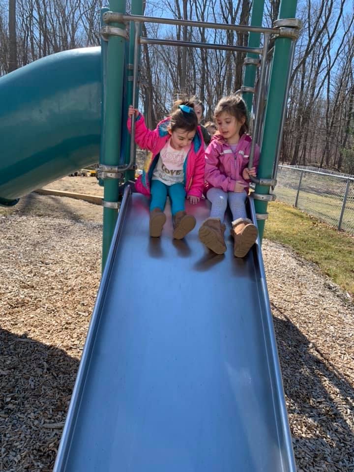 Two children sitting on a playground slide