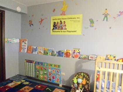 Playroom with a crib, wall decorations, and a sign that reads "Welcome to our Playroom"