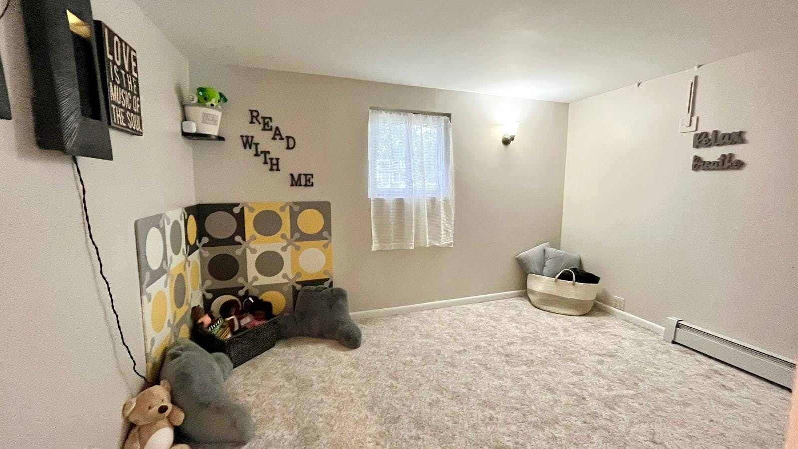 Child's room with toy storage, stuffed animals, and a window
