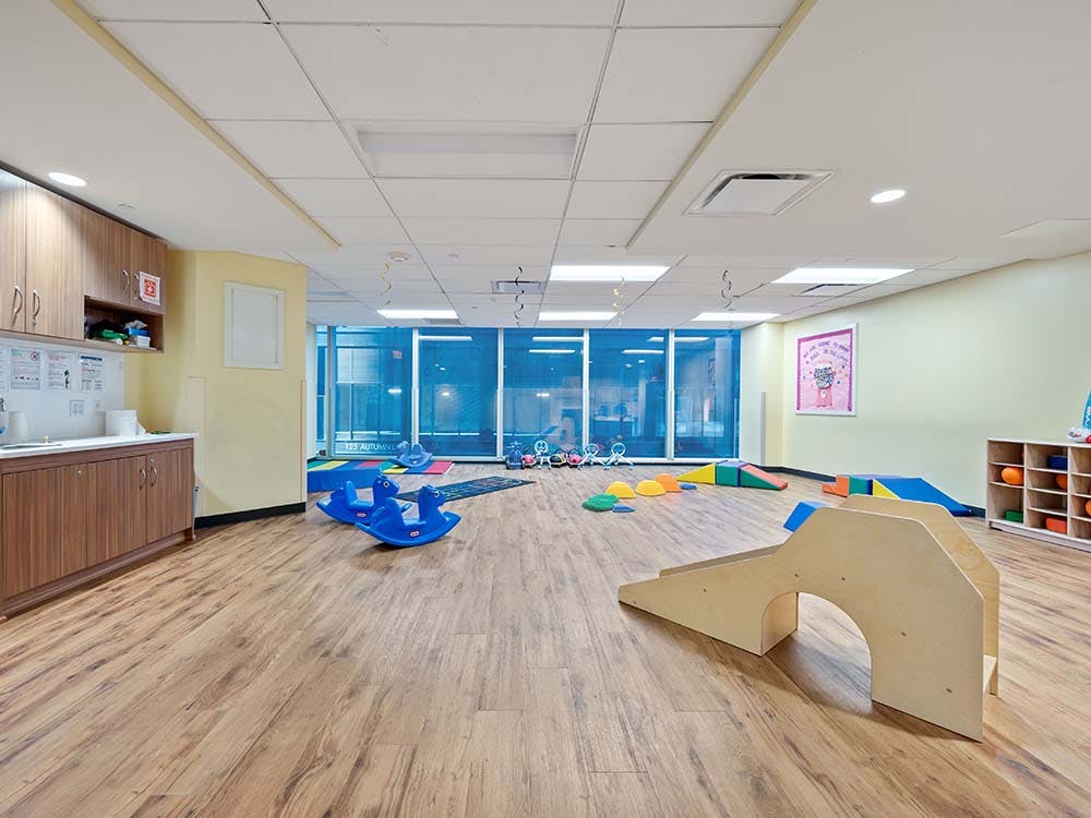 Empty children's playroom with wood floors and colorful toys
