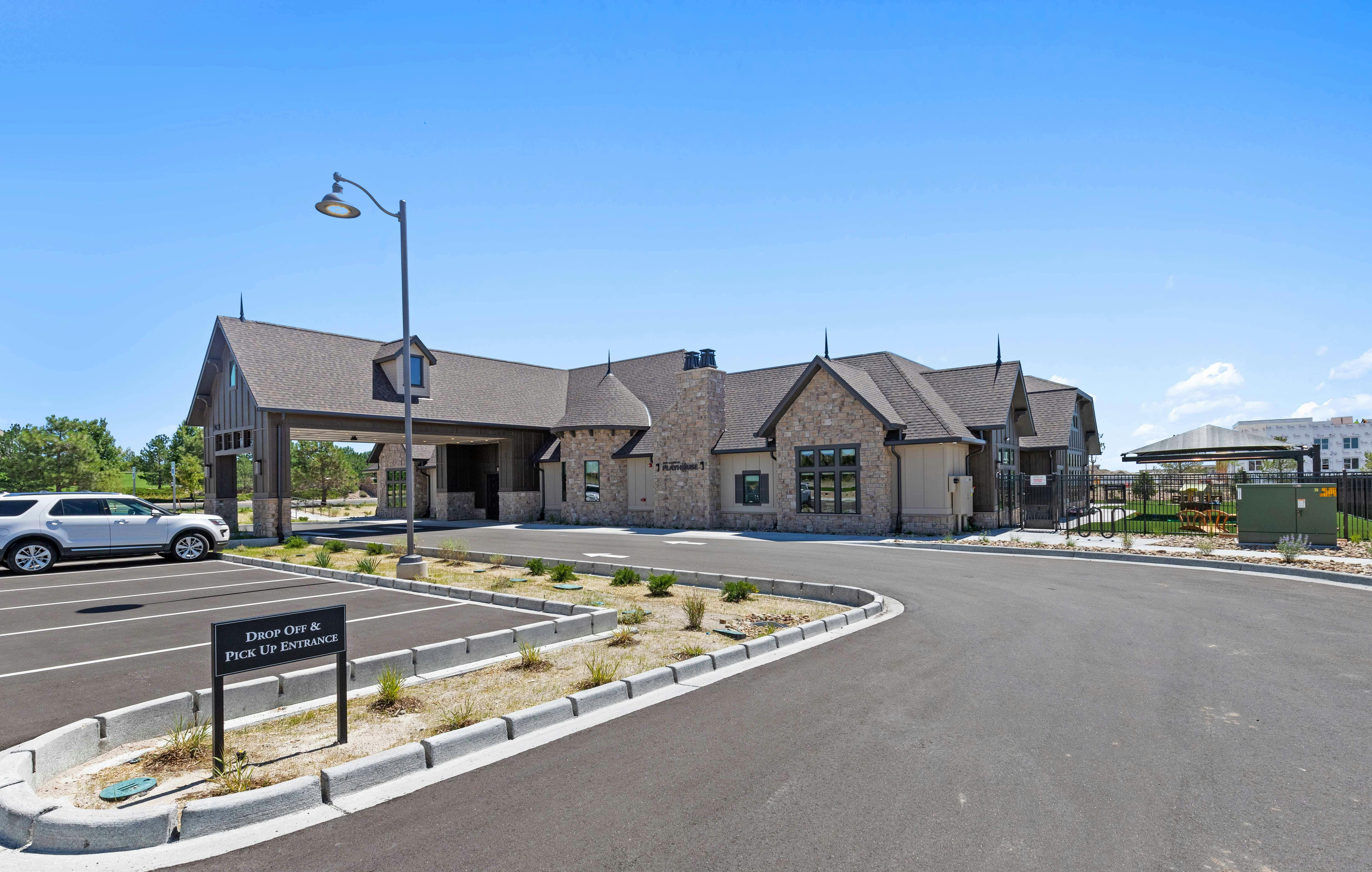 Building with a covered entrance and a parking lot