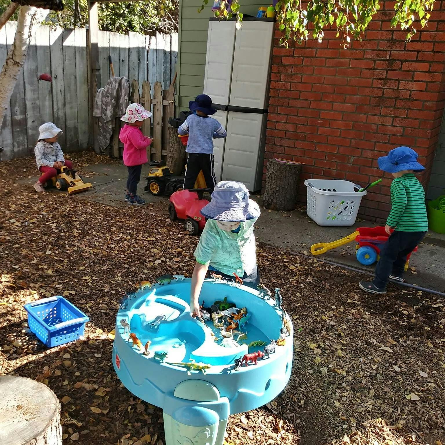 Children playing with toys in an outdoor area