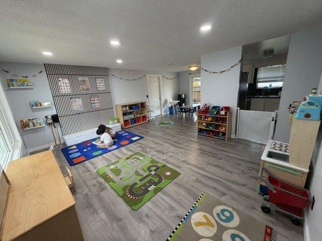 Children playing on floor mats in a daycare room