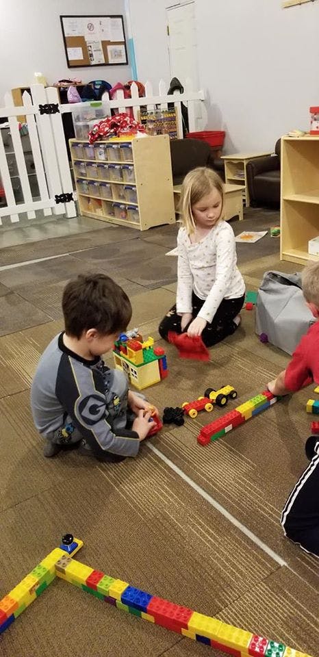 Children playing with building blocks on the floor
