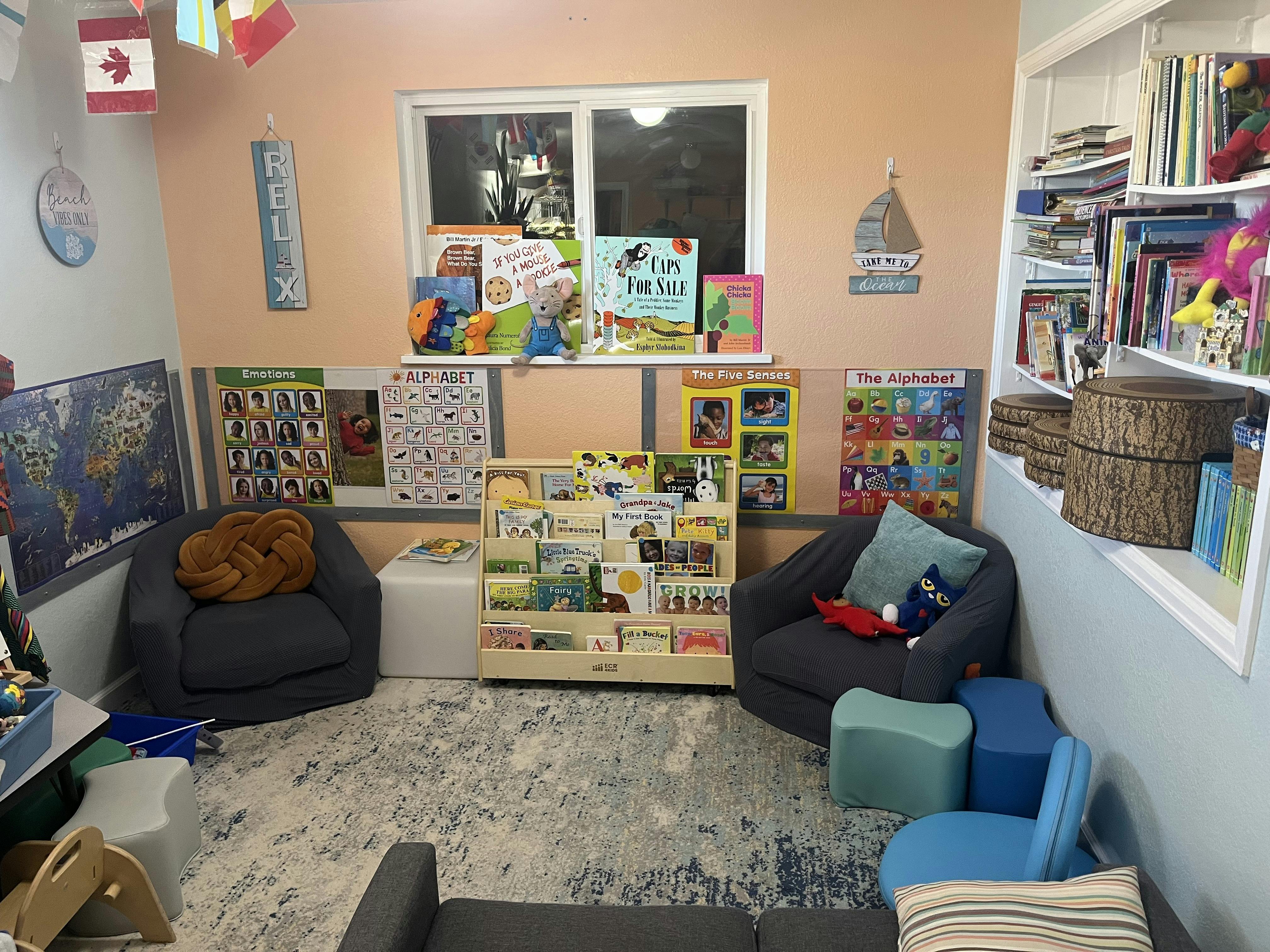Children's classroom with books, posters, and chairs