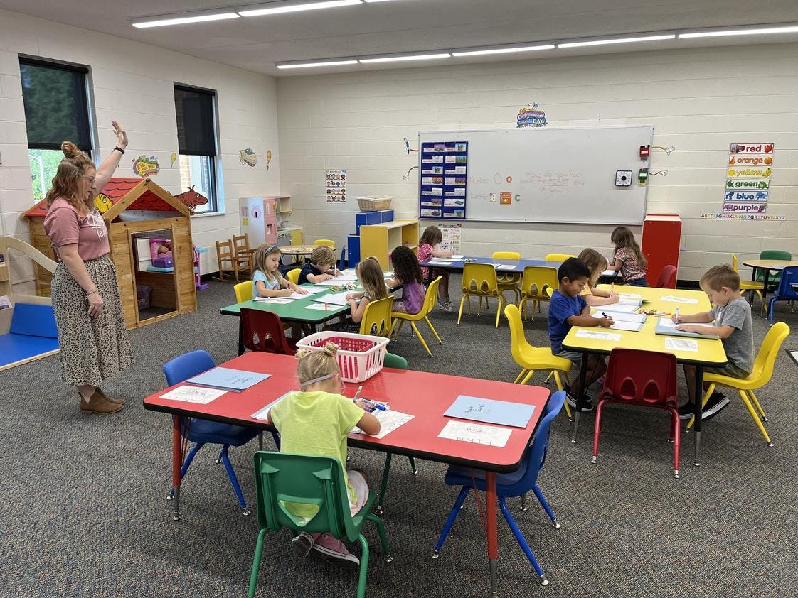 Adult and children in a classroom