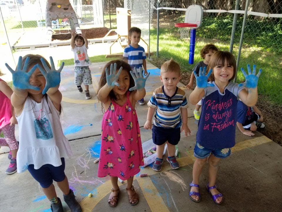 Children with blue paint on their hands