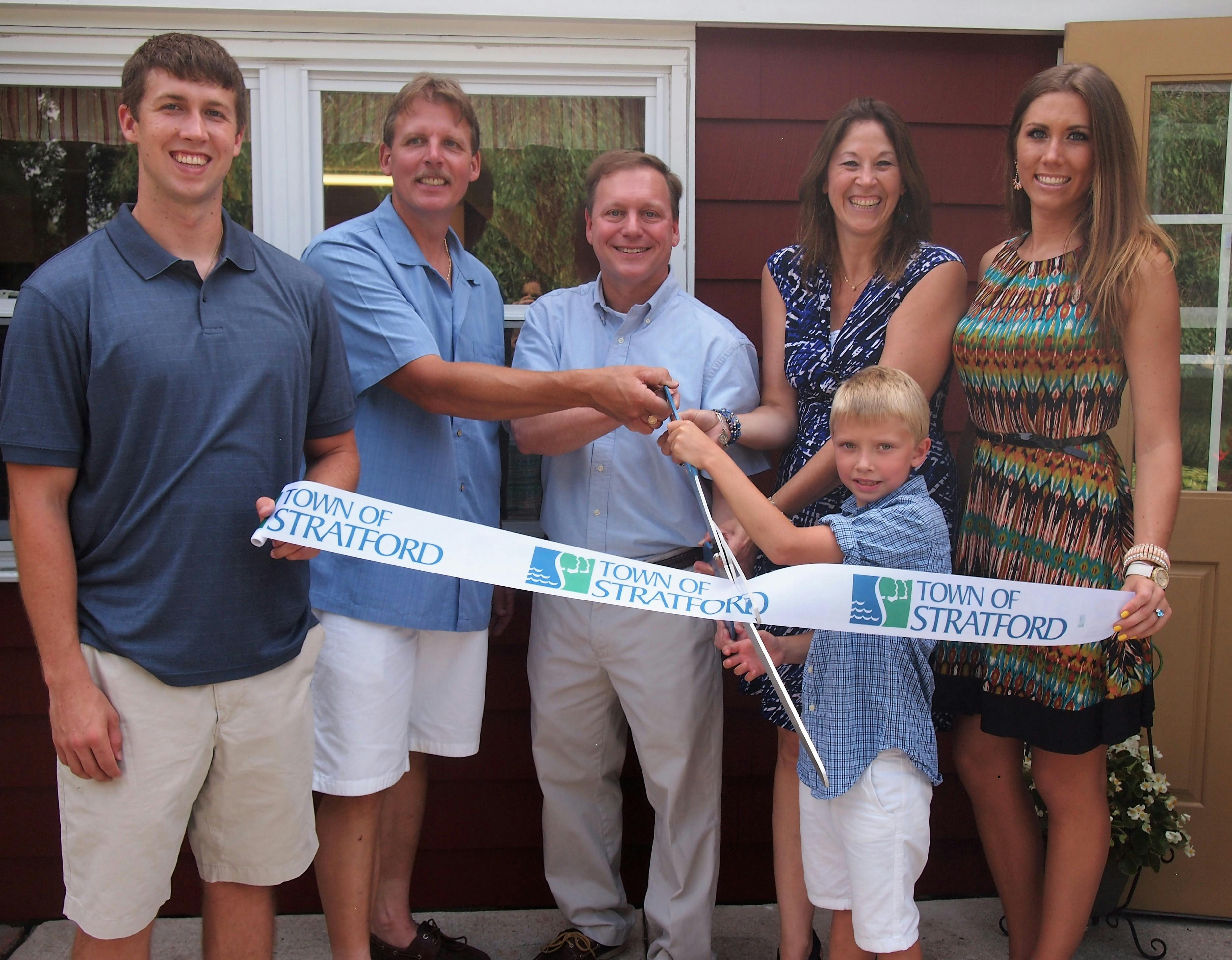 Group of people cutting a ribbon with Town of Stratford branding
