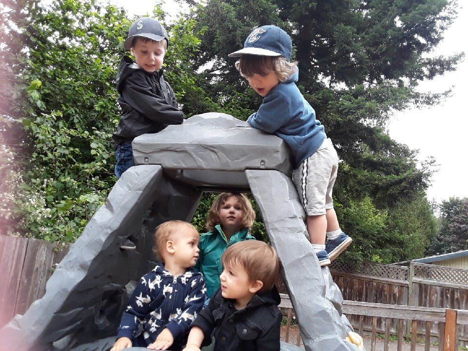 Children playing on a small climbing structure