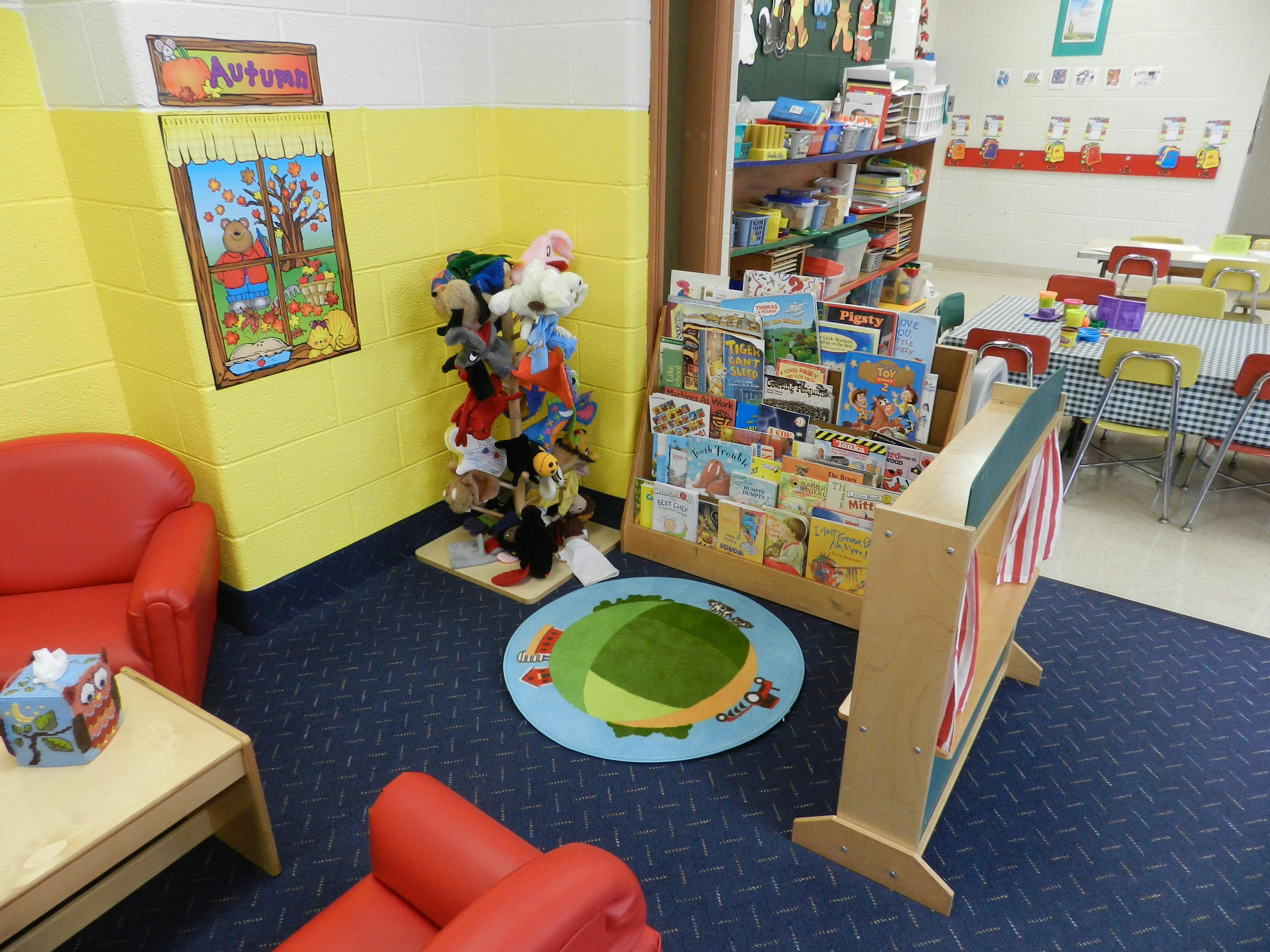 Children's classroom with books, toys, and small furniture