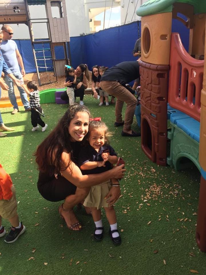 Person holding a child on a playground