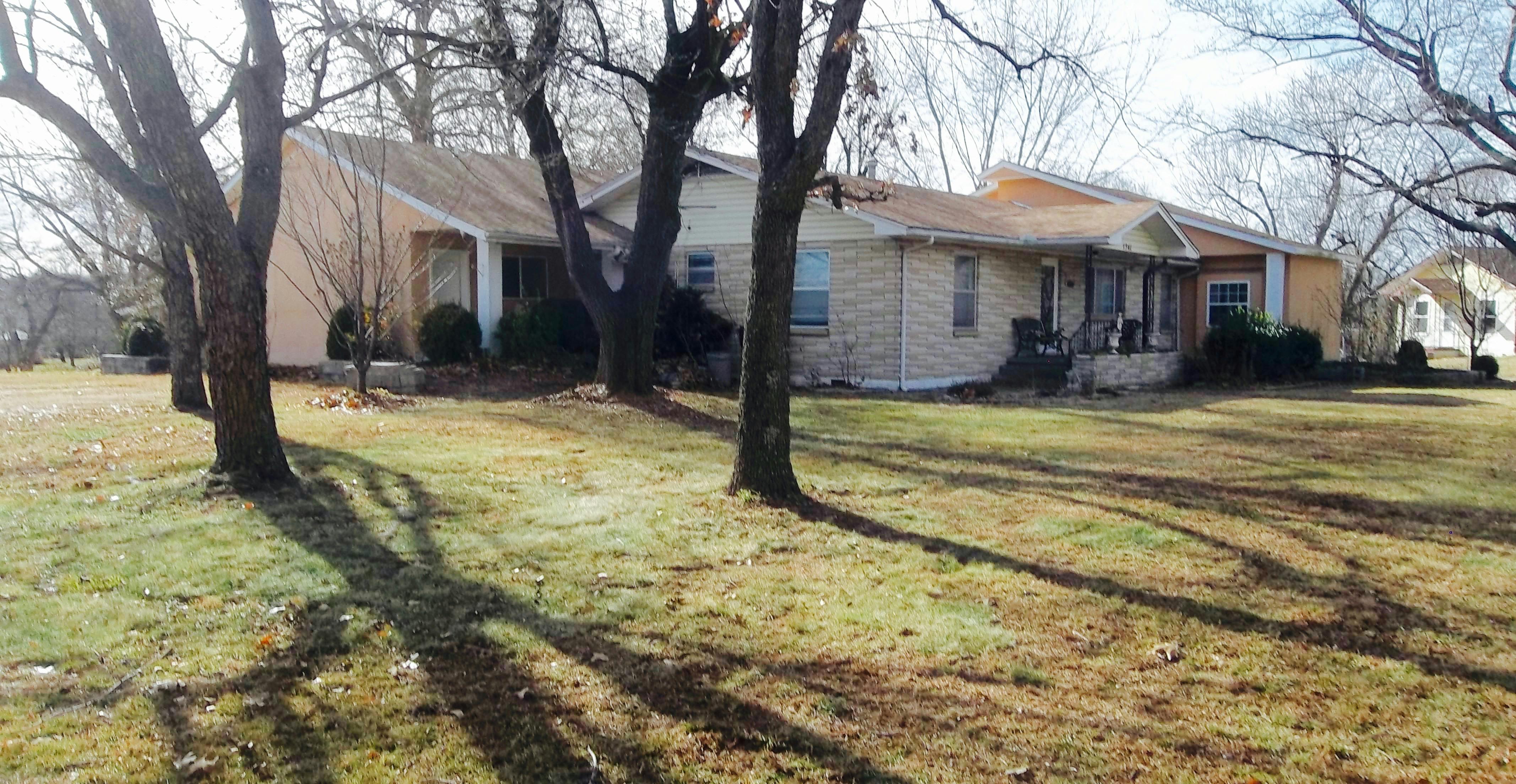 House with a large lawn and trees