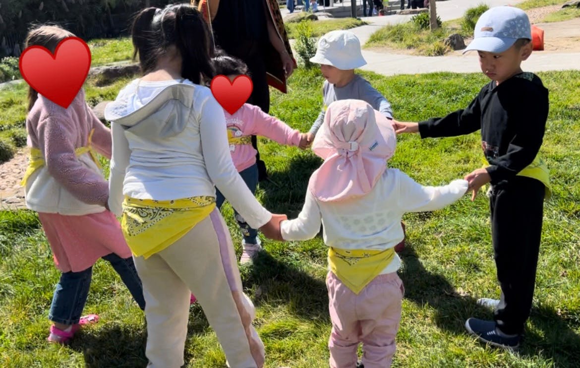 Children holding hands in a circle outdoors