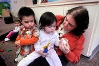 Adult person interacting with two children