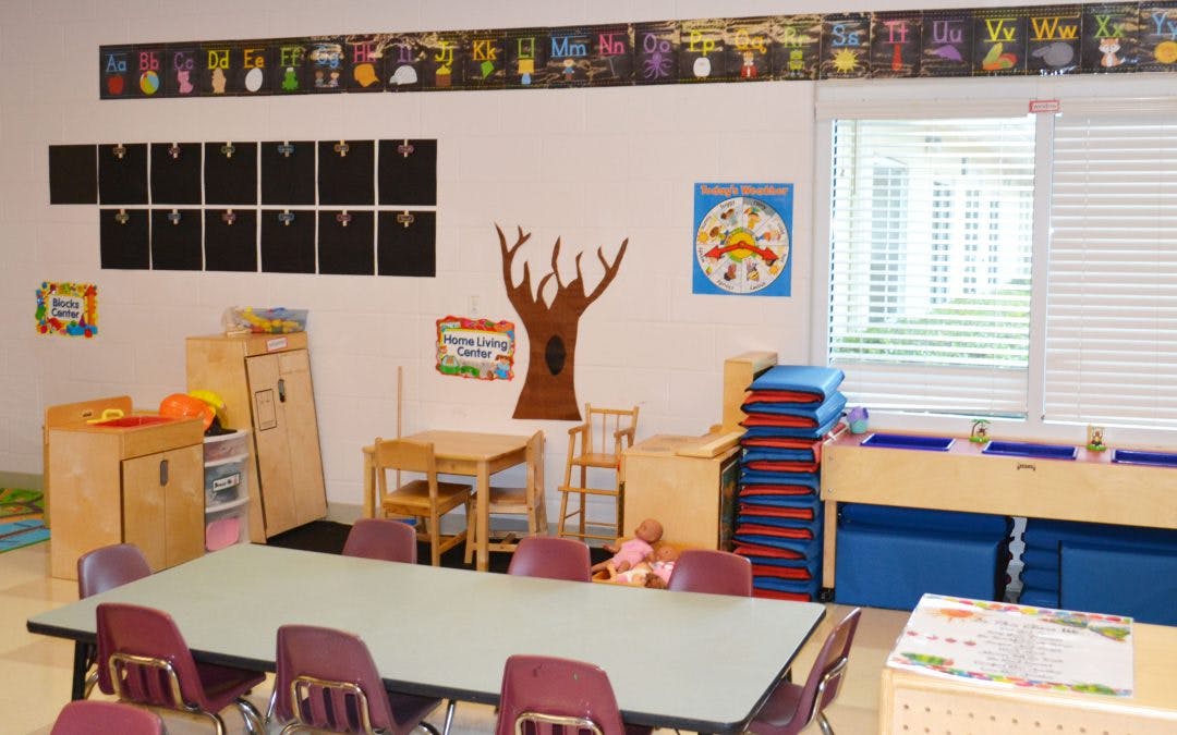 Empty classroom with small tables and chairs
