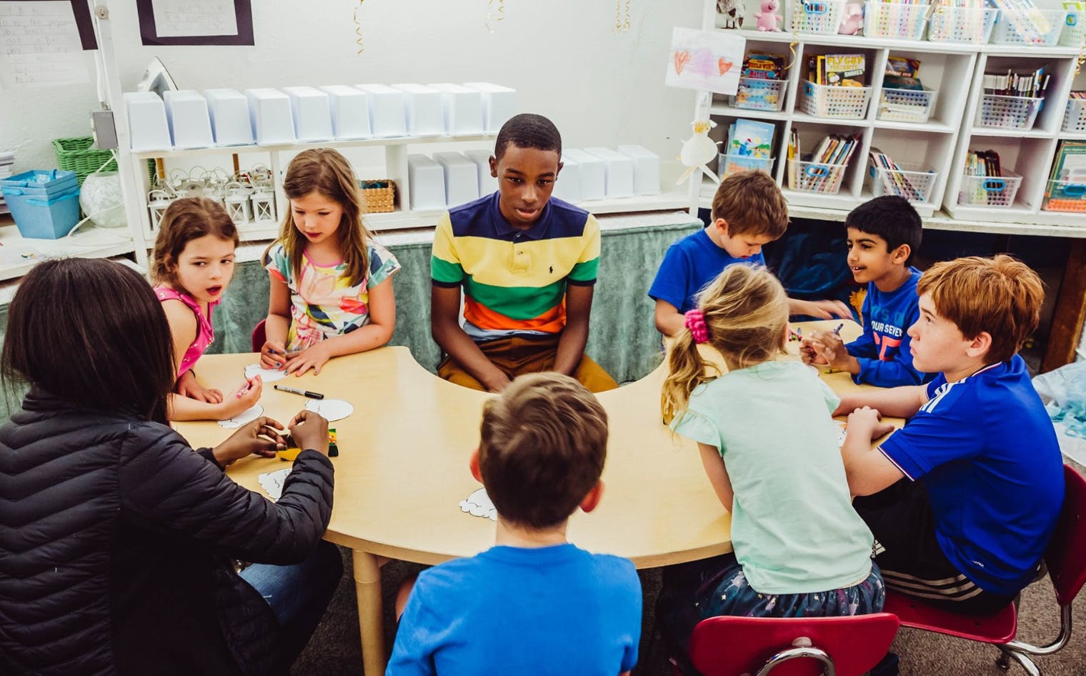 Adult and children sitting around a table