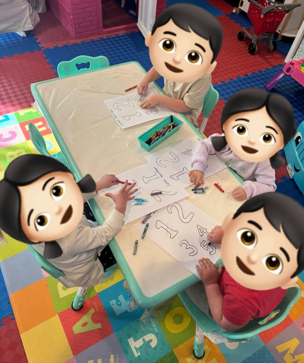 Four children coloring papers with numbers and text "Color Numbers" at a table