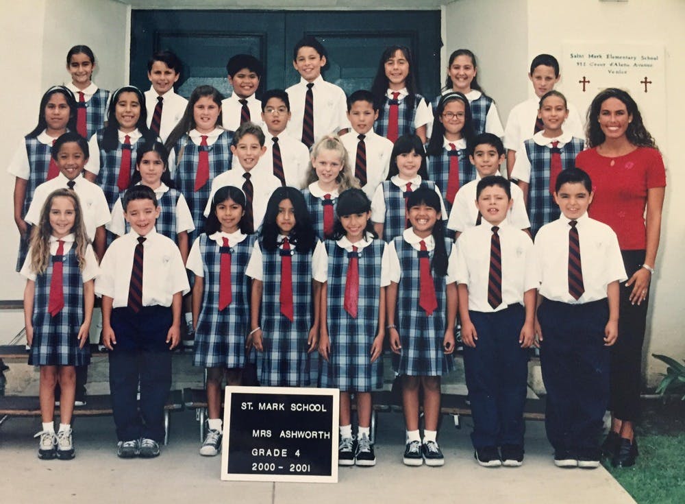 Group of children in school uniforms posing with a person, St. Mark School, 2000-2001
