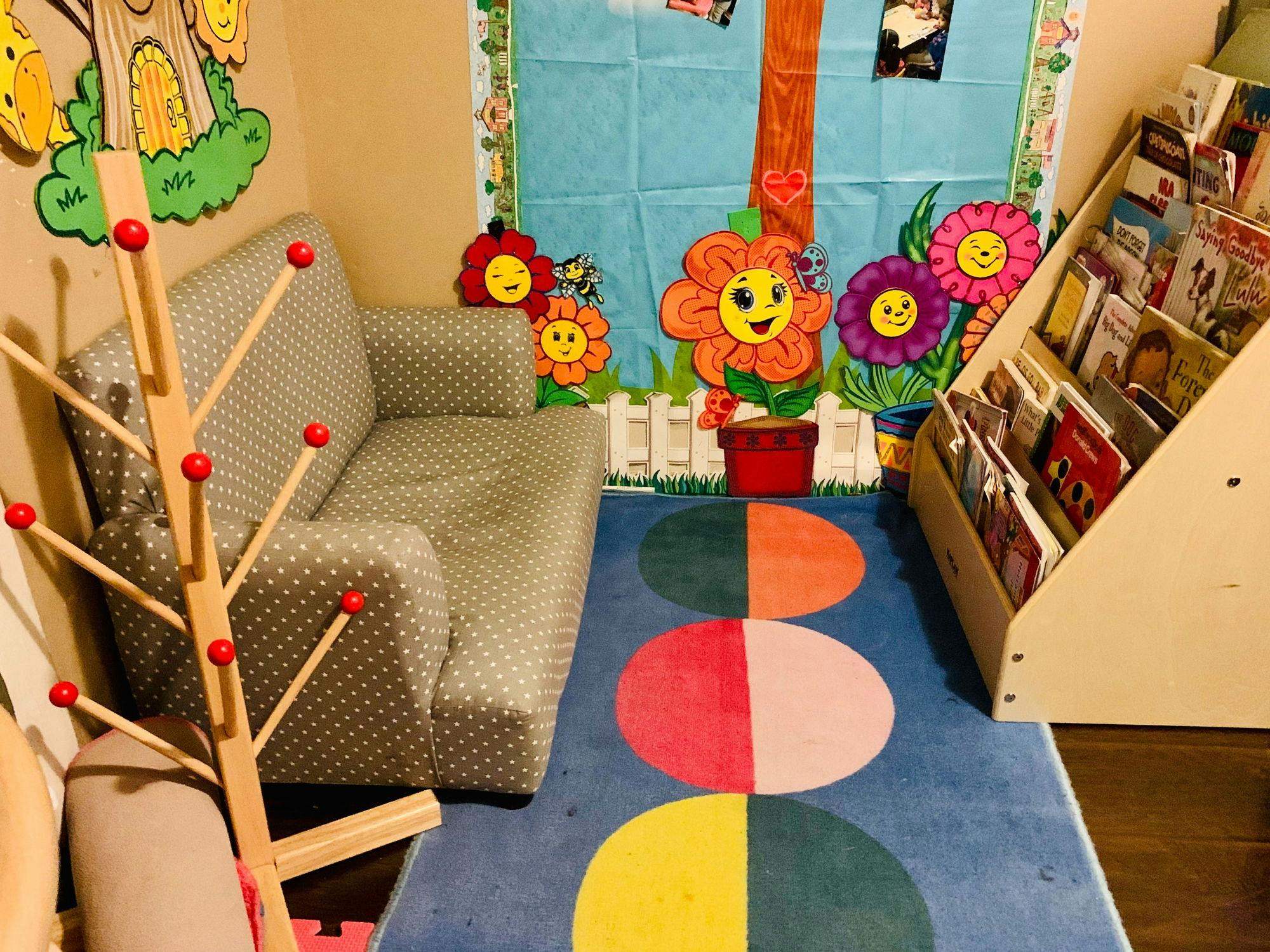Children's reading nook with a small sofa, bookshelf, and colorful rug
