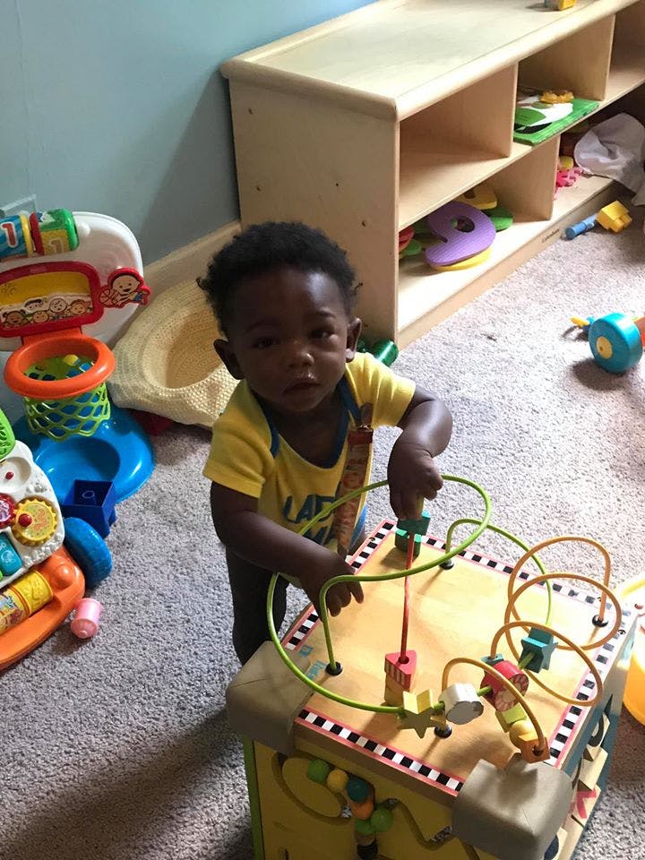 Child playing with a bead maze toy