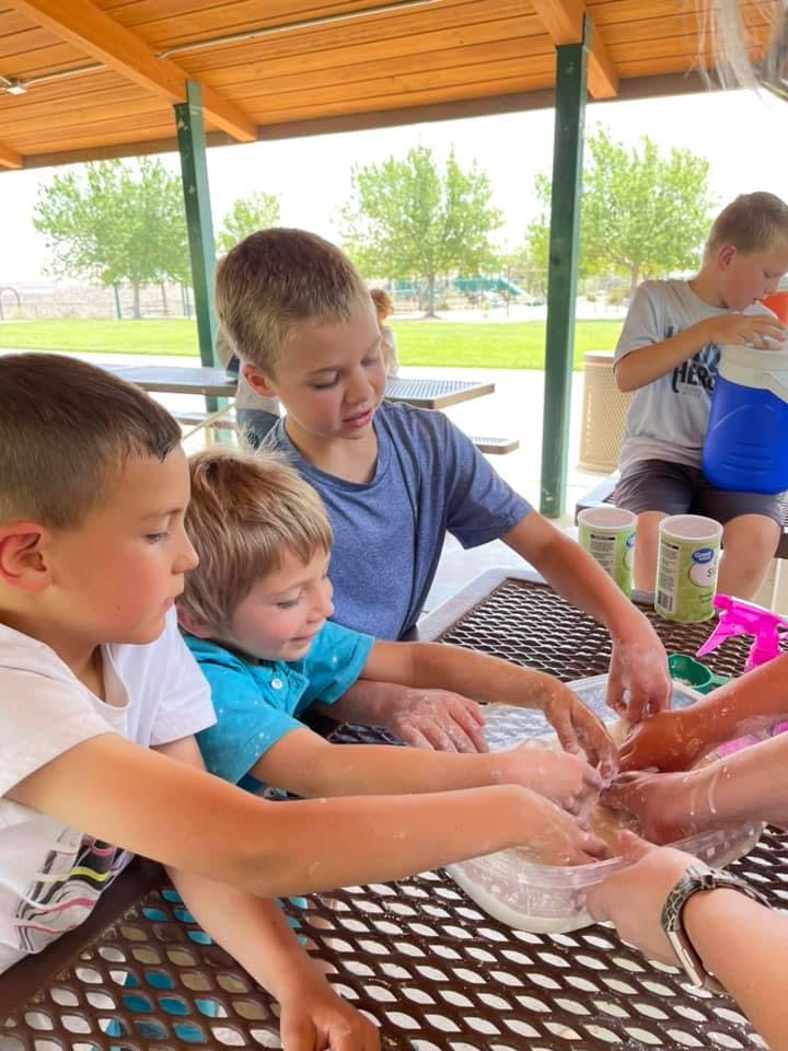 Children playing with a sensory bin at a table