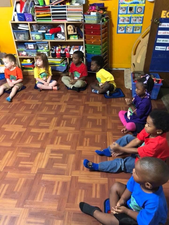 Children sitting on the floor in a classroom