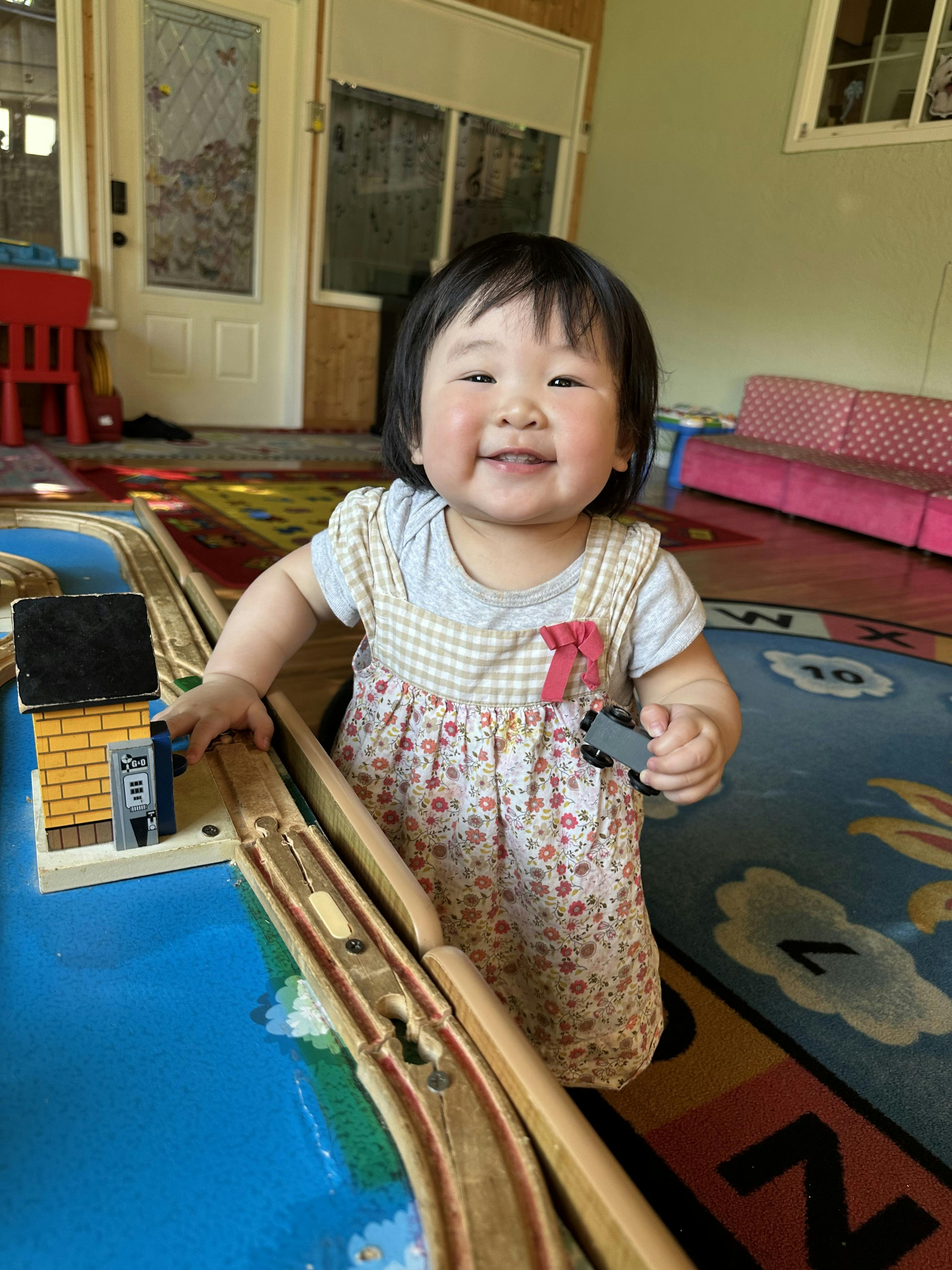 Child playing with a toy train set