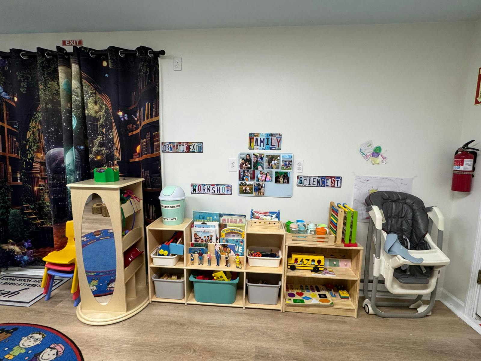 Children's play area with shelves of toys, a mirror, and a high chair