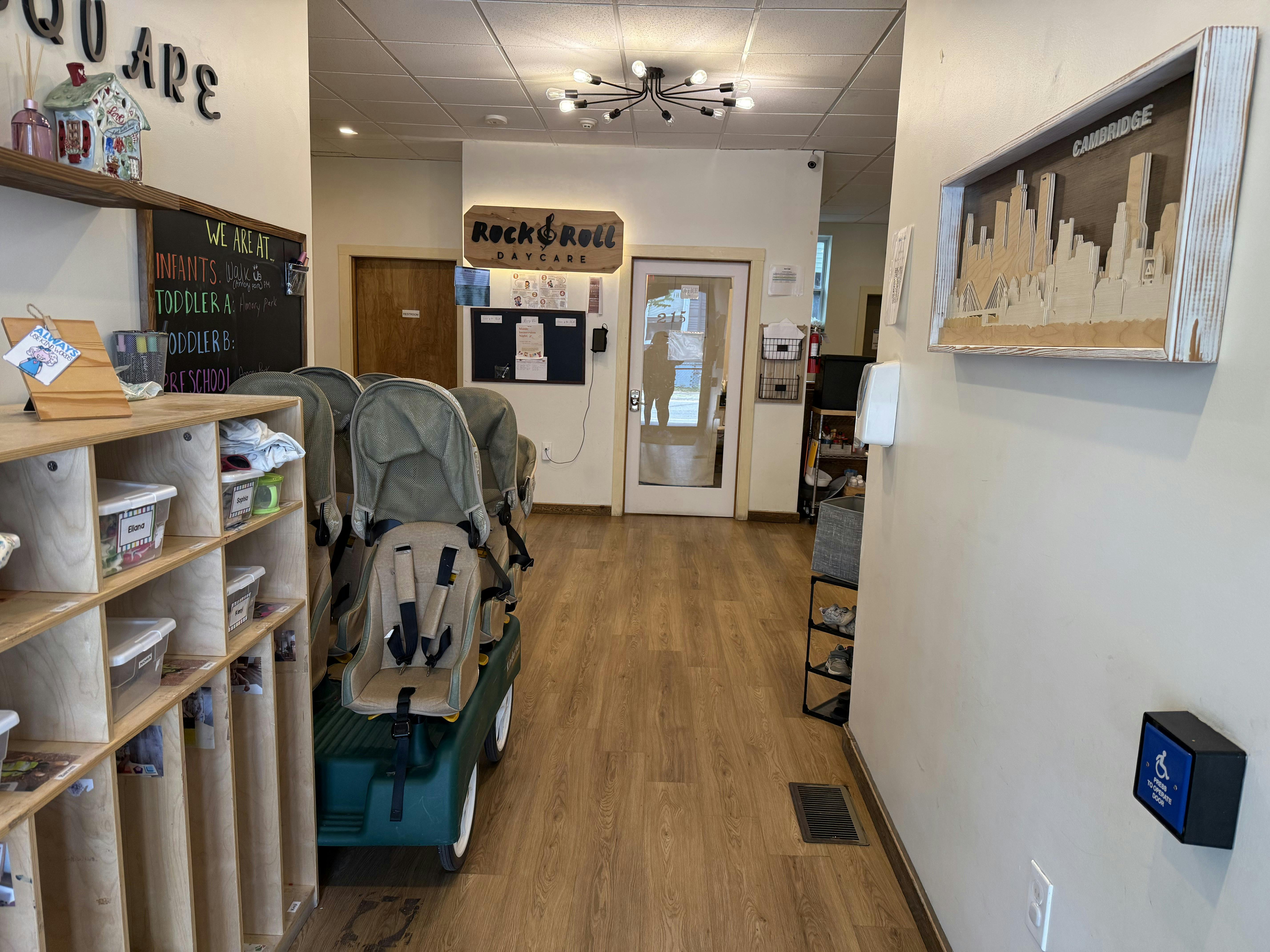 Hallway with wooden floors, shelves, and a wagon with child carriers