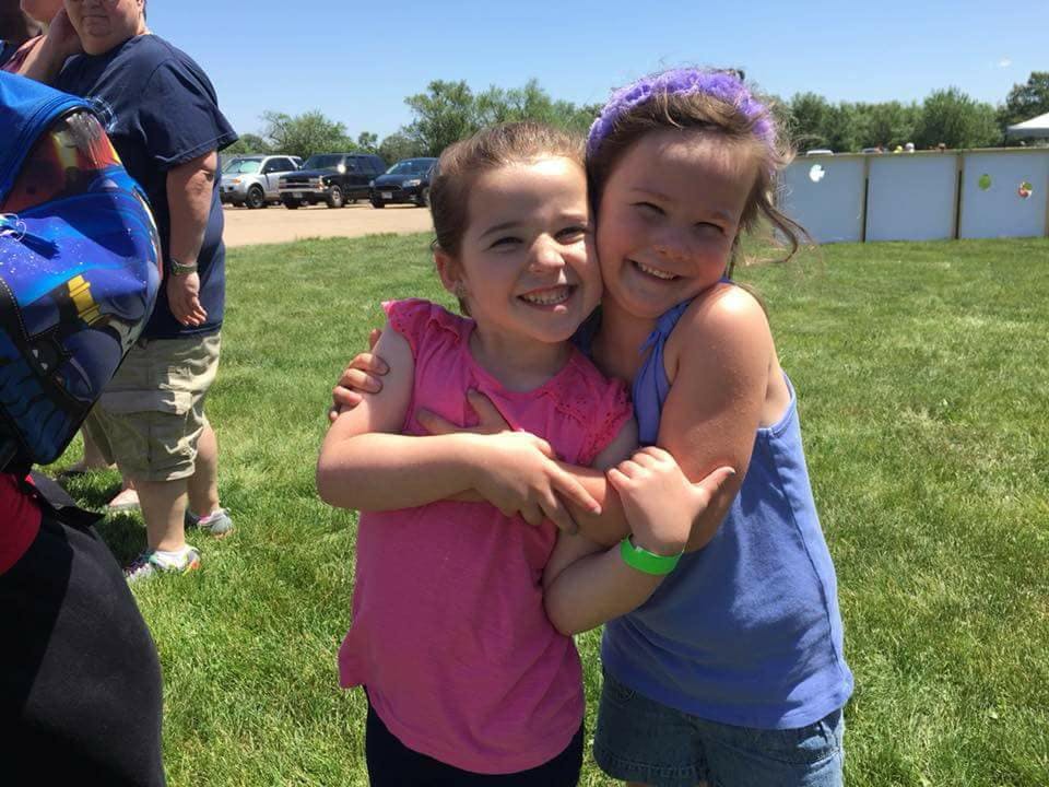 Two children hugging outdoors