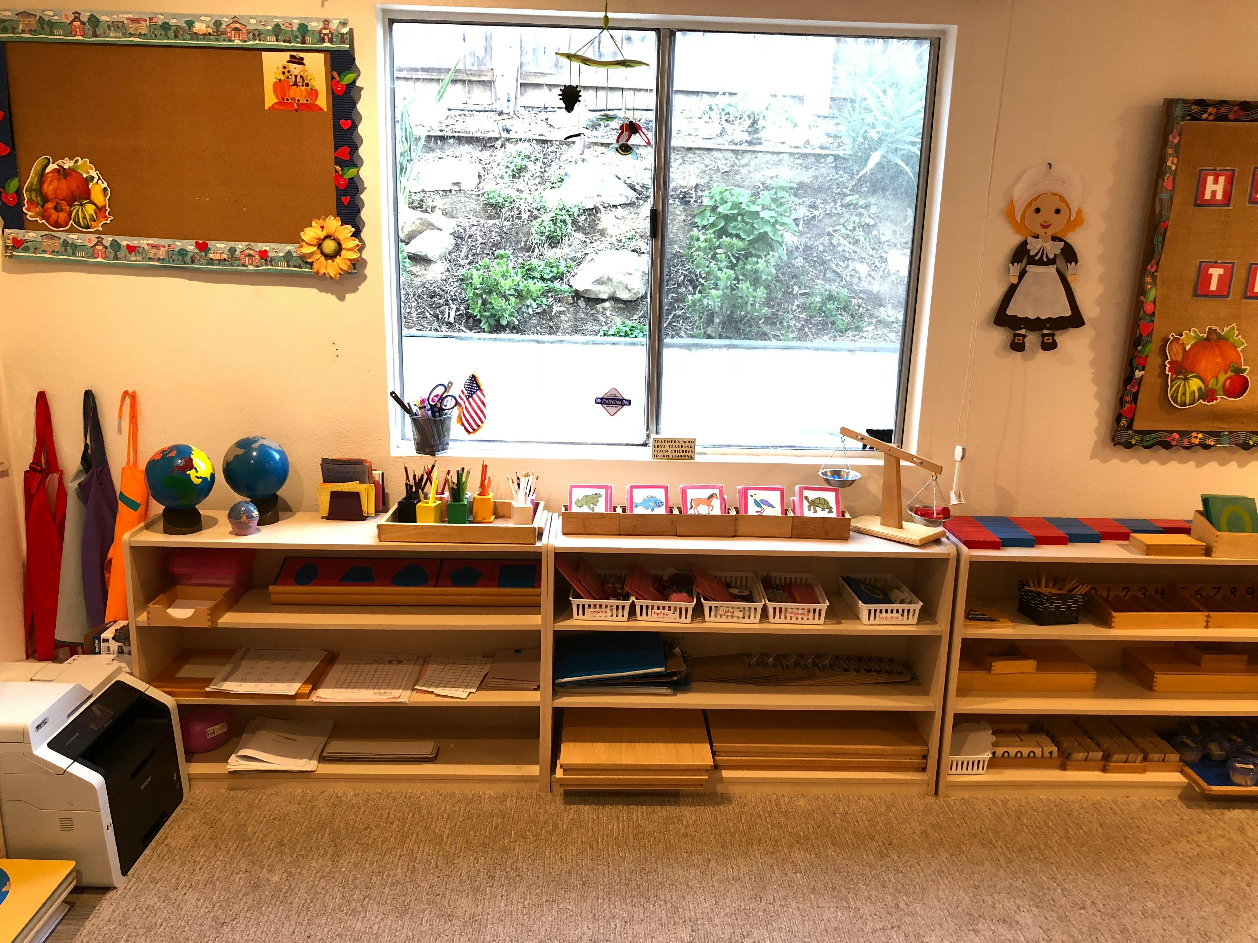 Classroom with shelves of learning materials and a large window