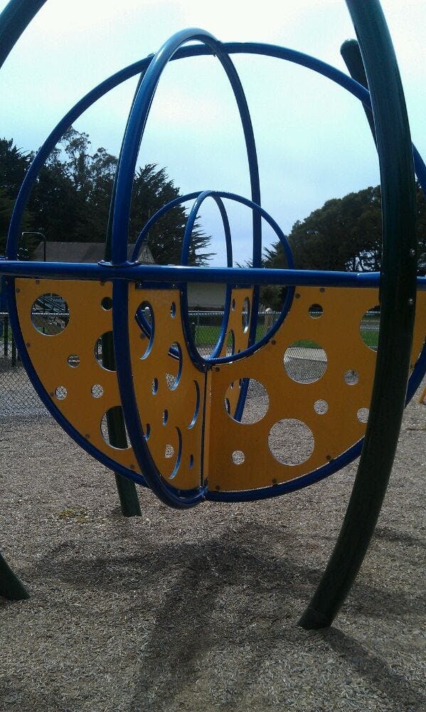 Blue and yellow playground equipment with circular cutouts