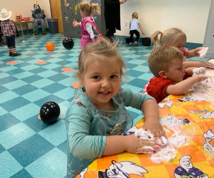 Child playing with foam at a table