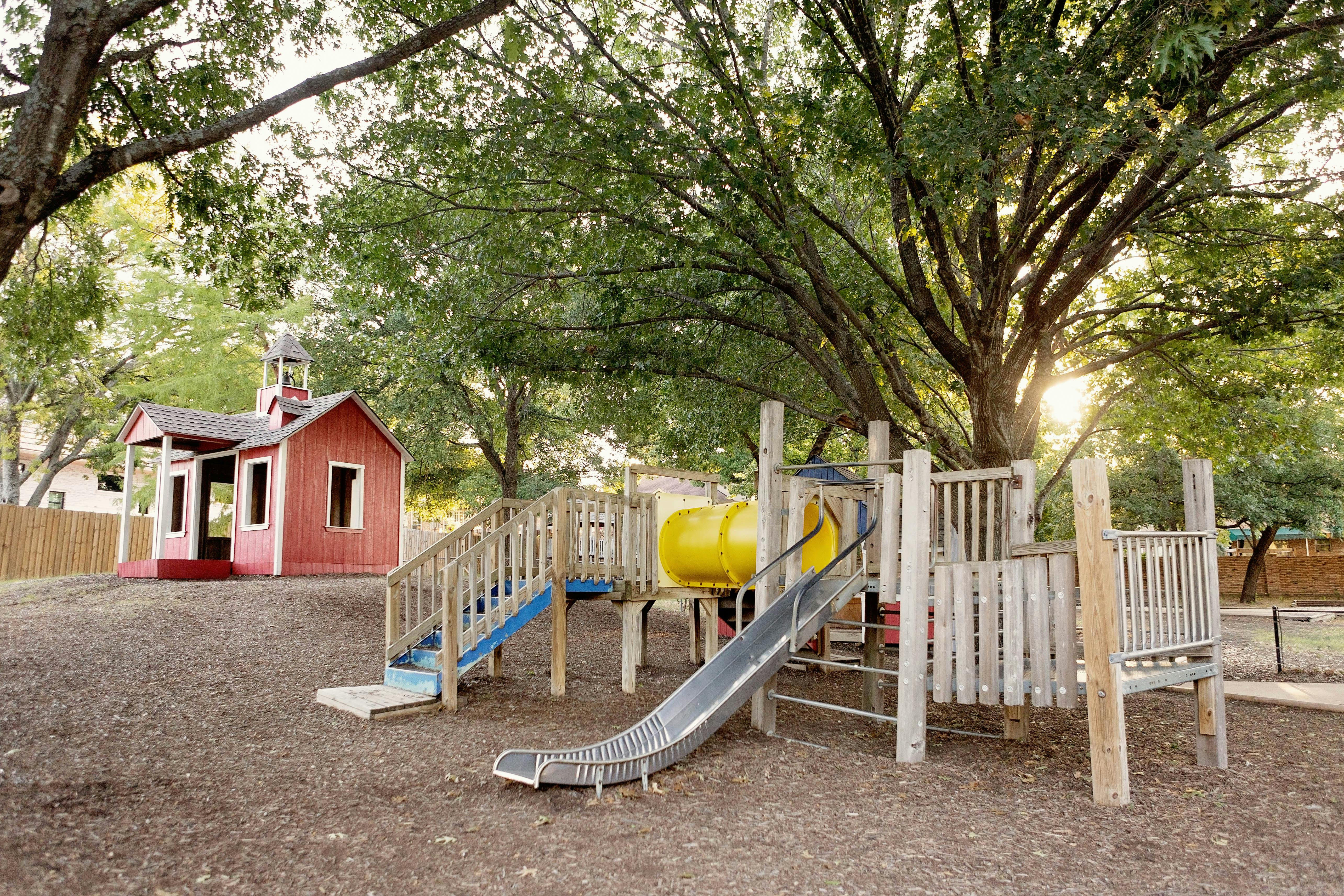 Playground with slides and a red playhouse
