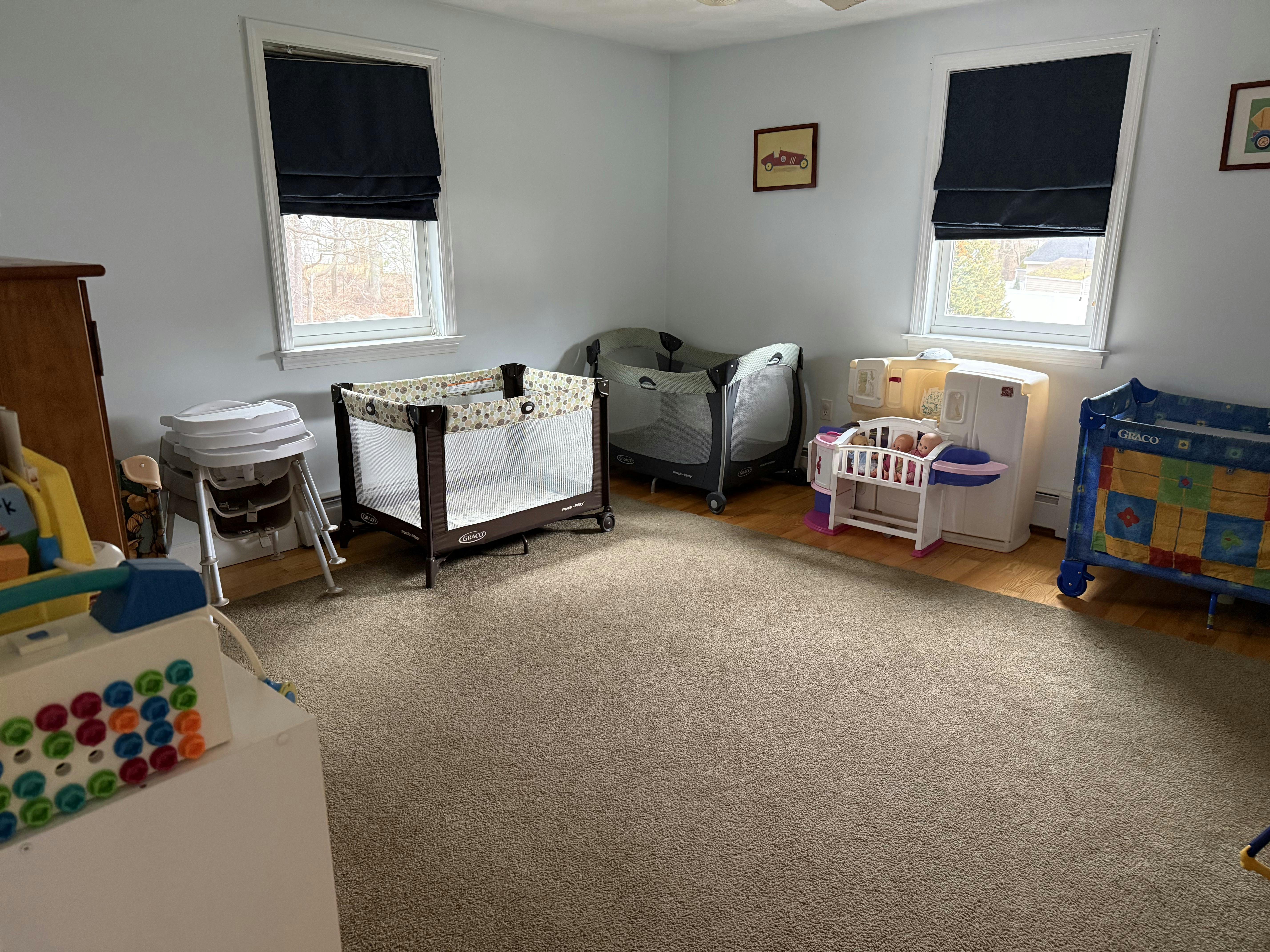 Room with multiple baby cribs and playpens