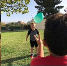 Child playing with a balloon outdoors