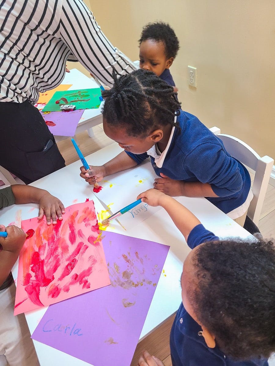 Children painting at a table