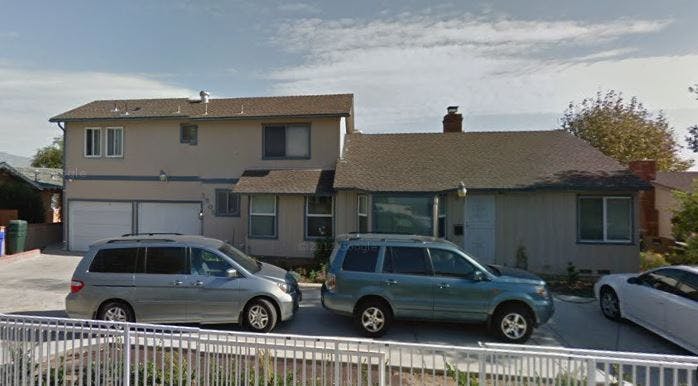 House with two cars parked in front