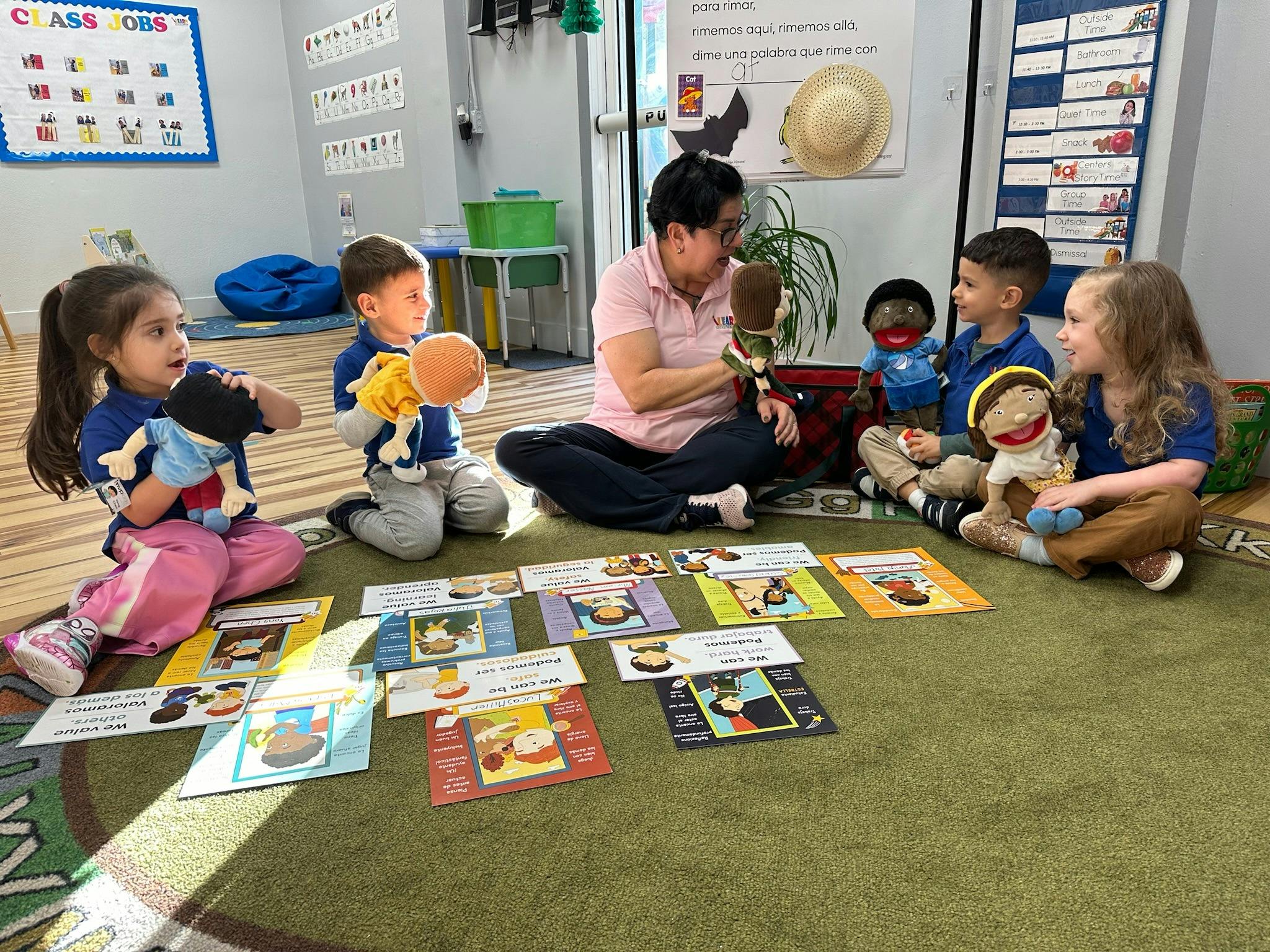 Teacher and children using hand puppets during a classroom lesson
