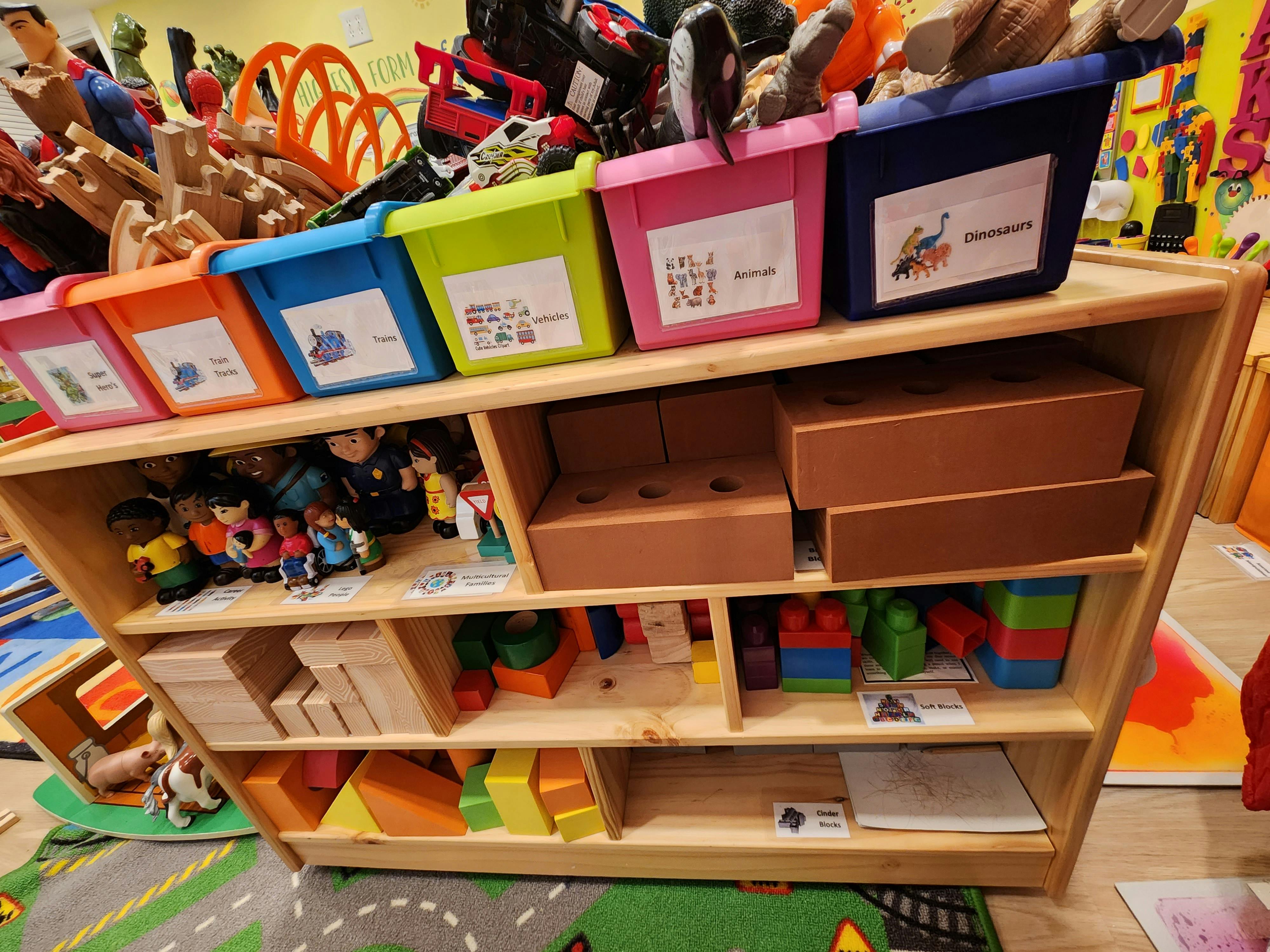 Wooden shelf with colorful bins and toys