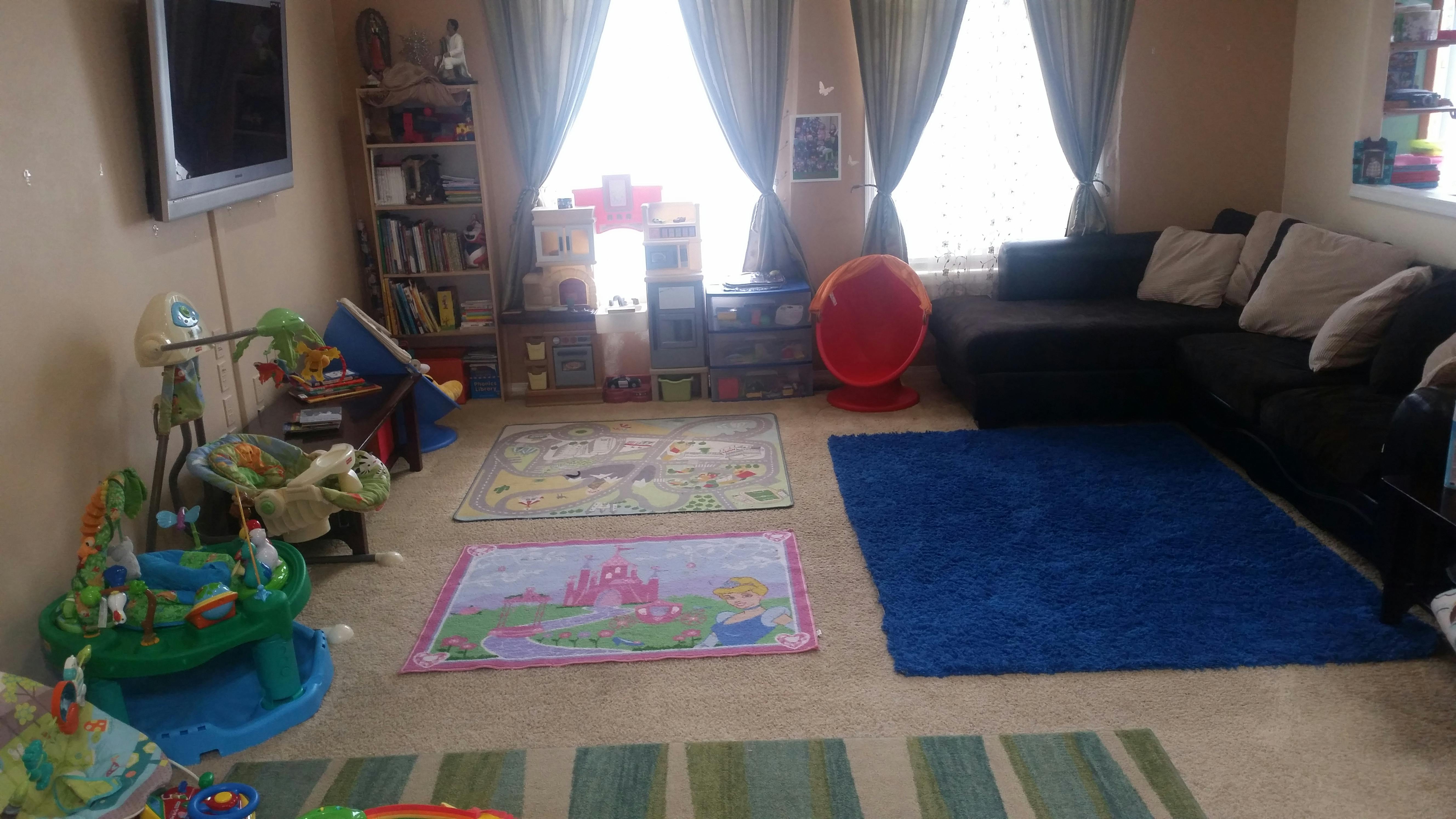 Playroom with area rugs, toy sets, and an entertainment console