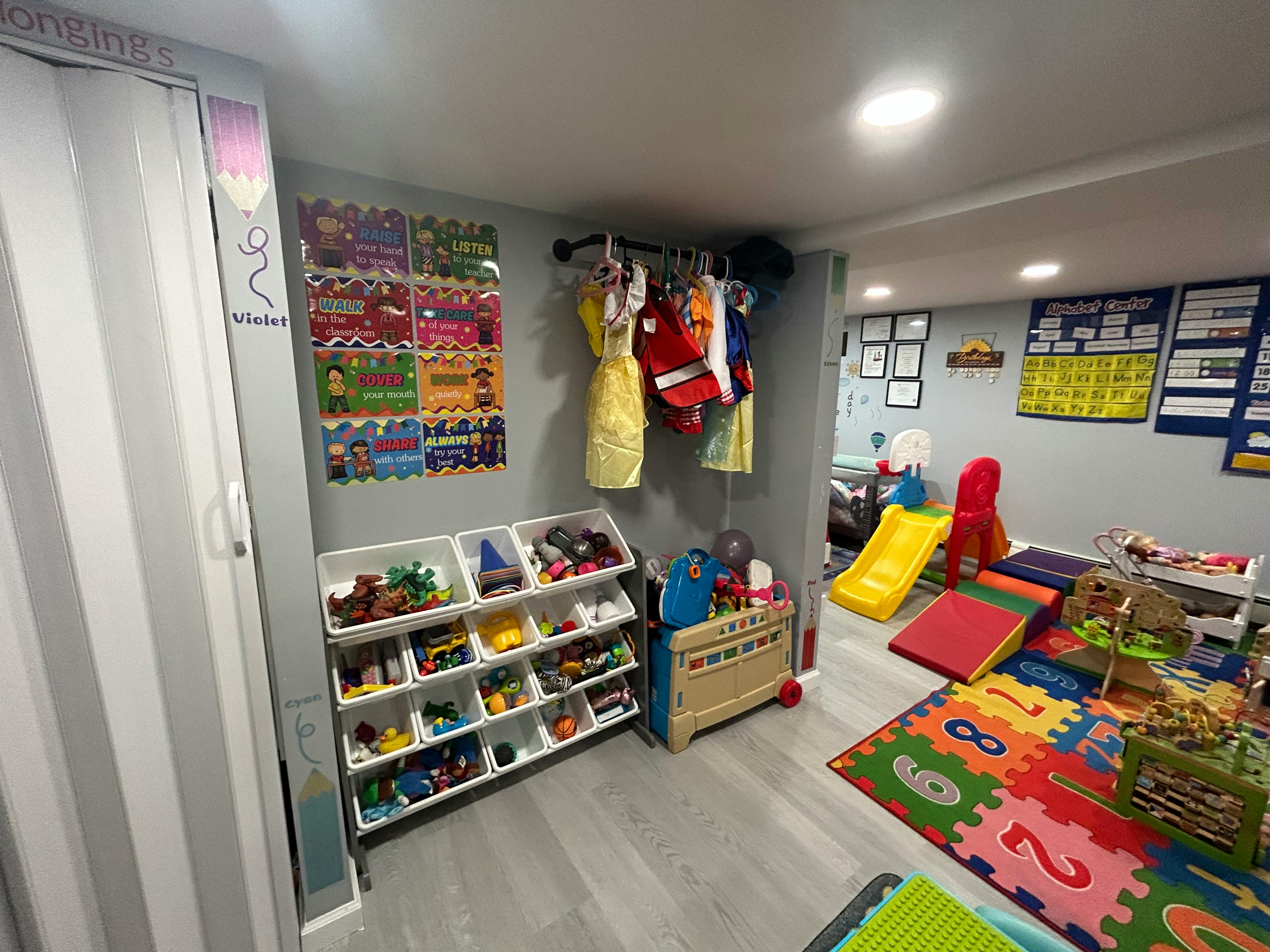 Playroom with toy storage, clothes rack, and play equipment