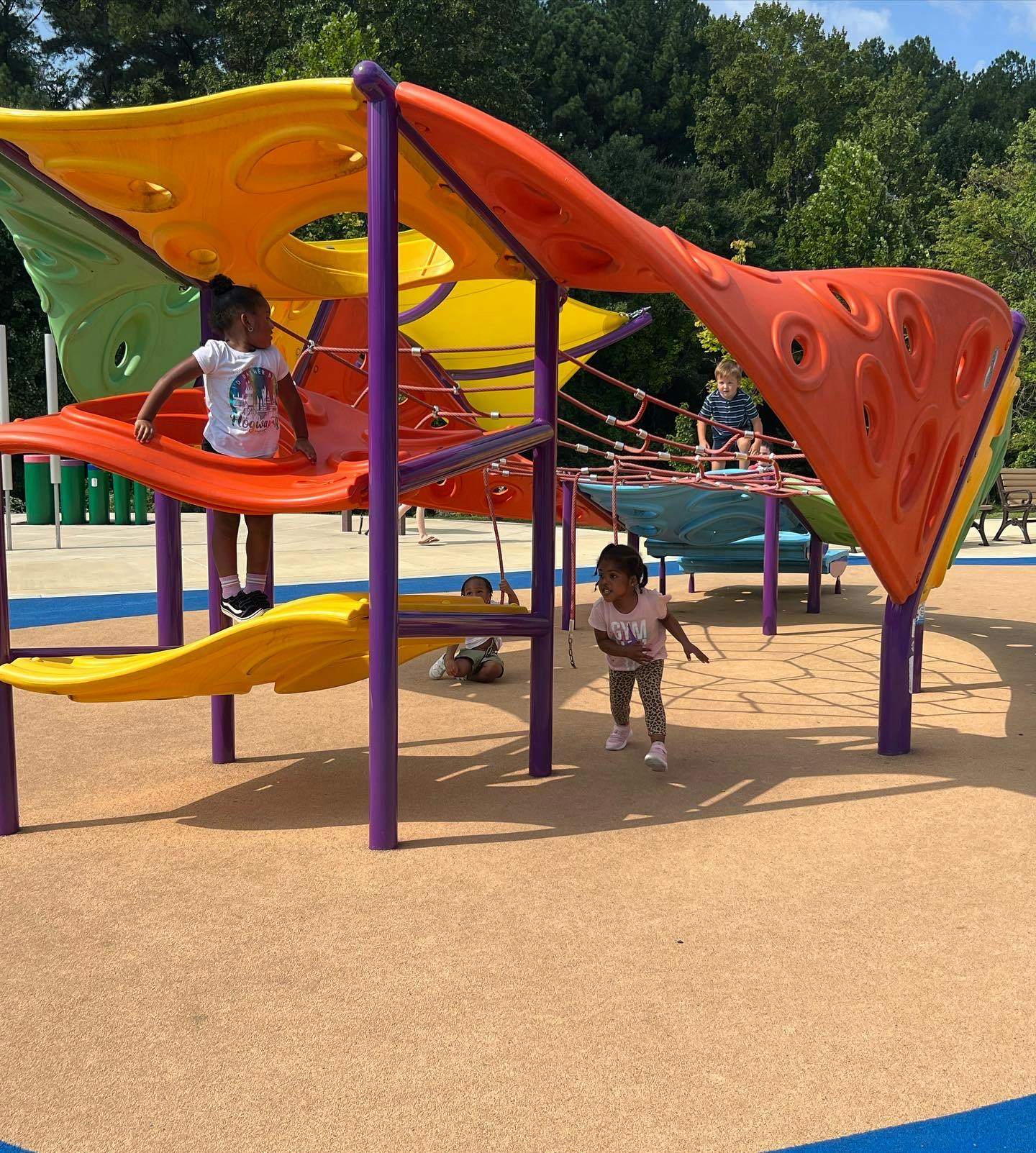 Children playing on a colorful playground structure