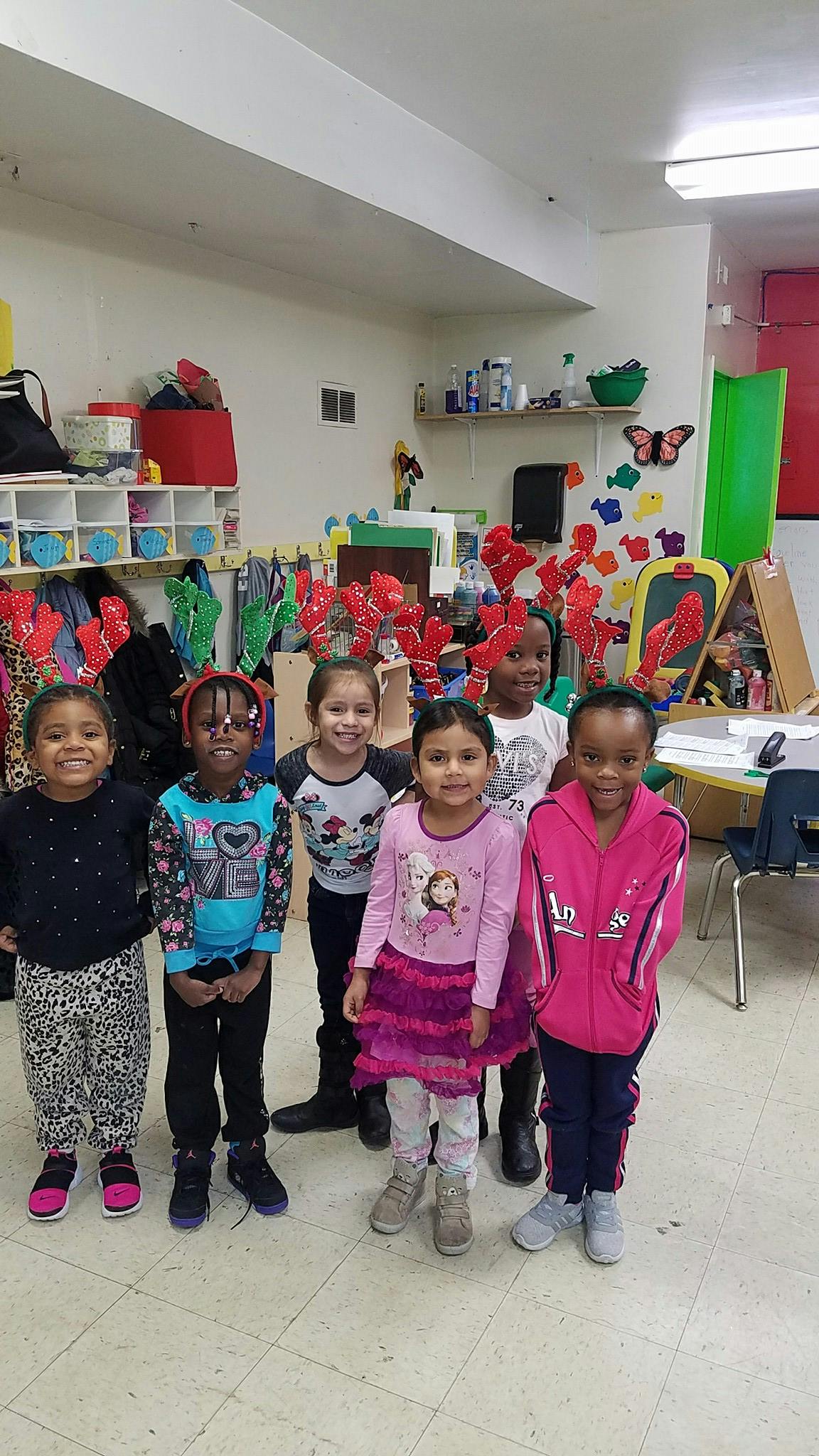 Group of children standing in a classroom