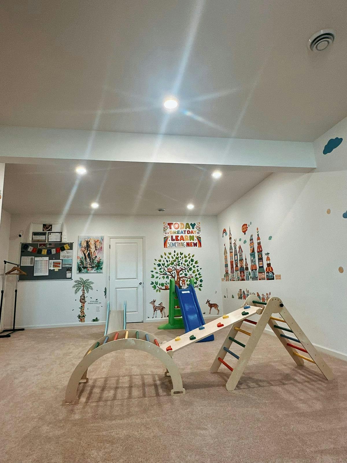 Indoor play area with a slide and climbing structures