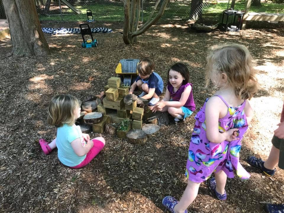 Children playing with blocks outdoors
